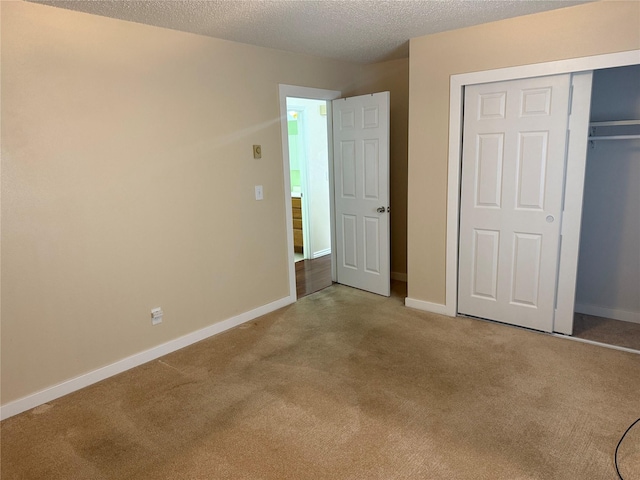 2720 Bandera Dr, East Helena, MT 59635 - unfurnished bedroom with carpet, a closet, a textured ceiling, and baseboards