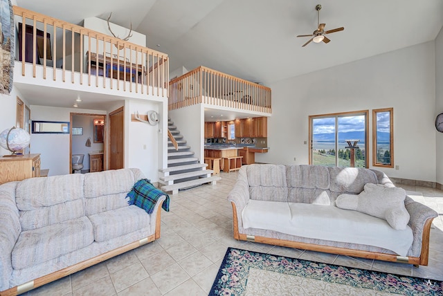 199 Mountain View Trl, White Sulphur Springs, MT 59645 - living room with high vaulted ceiling, a ceiling fan, stairs, and light tile patterned floors