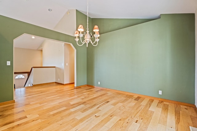 3721 Brandon Way, Missoula, MT 59803 - unfurnished room featuring wood finished floors, a chandelier, baseboards, arched walkways, and high vaulted ceiling