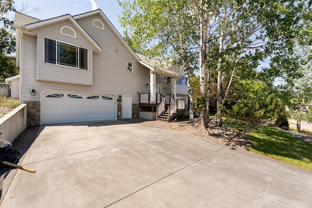3721 Brandon Way, Missoula, MT 59803 - view of front of home with stone siding, an attached garage, and concrete driveway