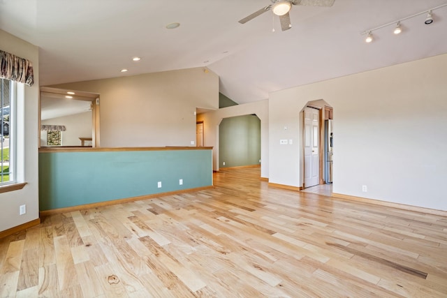 3721 Brandon Way, Missoula, MT 59803 - unfurnished room featuring vaulted ceiling, a ceiling fan, wood finished floors, arched walkways, and baseboards