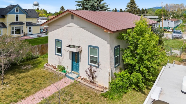 305 S Cedar St, Townsend, MT 59644 - view of side of property with stucco siding and metal roof