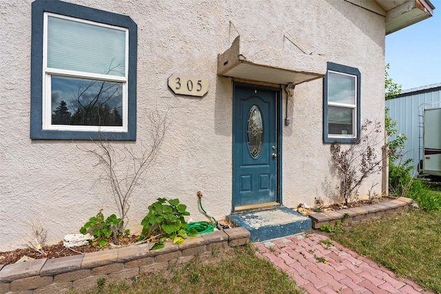 305 S Cedar St, Townsend, MT 59644 - doorway to property featuring stucco siding