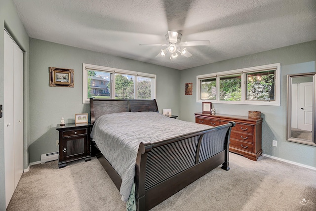 2 N Oregon St, Helena, MT 59601 - bedroom with light colored carpet, baseboard heating, baseboards, a textured ceiling, and a closet