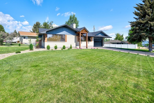 2 N Oregon St, Helena, MT 59601 - view of front facade featuring concrete driveway, an attached garage, a chimney, and brick siding