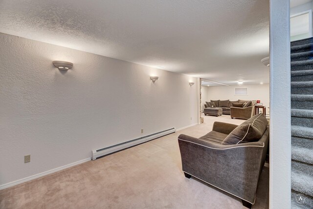 2 N Oregon St, Helena, MT 59601 - living area with a baseboard heating unit, stairway, light colored carpet, baseboards, and a textured wall