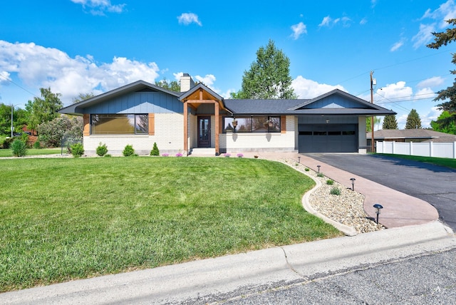 2 N Oregon St, Helena, MT 59601 - view of front of house with brick siding, an attached garage, asphalt driveway, and a chimney
