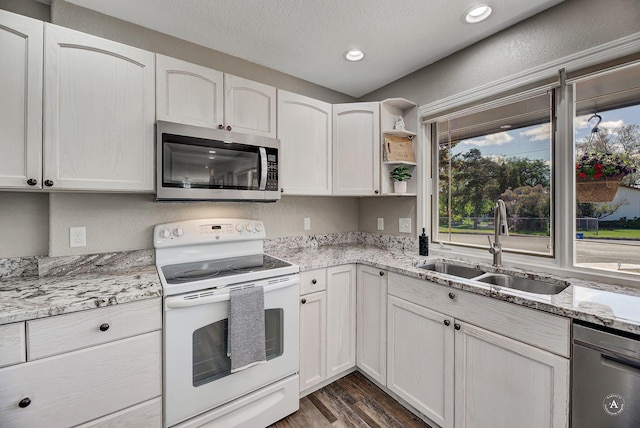 2 N Oregon St, Helena, MT 59601 - kitchen with stainless steel appliances, a sink, dark wood-type flooring, light stone counters, and open shelves