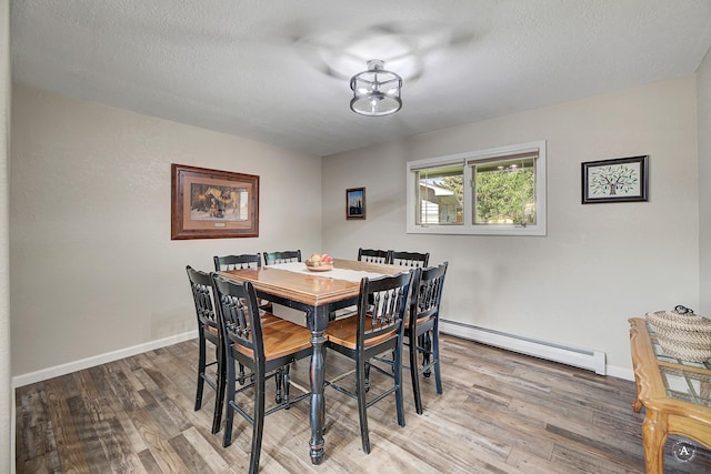 2 N Oregon St, Helena, MT 59601 - dining area with a baseboard radiator, wood finished floors, baseboards, and a textured ceiling