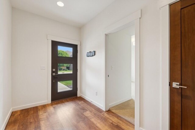 147 Hawthorne Ct Unit B, Whitefish, MT 59937 - foyer with light wood-type flooring, plenty of natural light, and baseboards