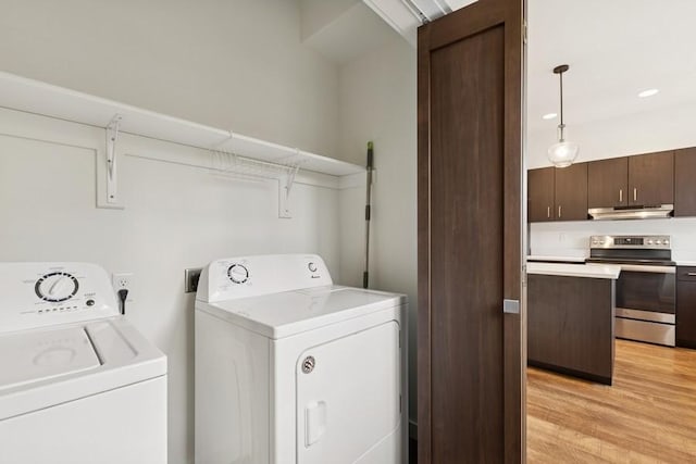 147 Hawthorne Ct Unit B, Whitefish, MT 59937 - laundry room with washer and clothes dryer and light wood-style floors