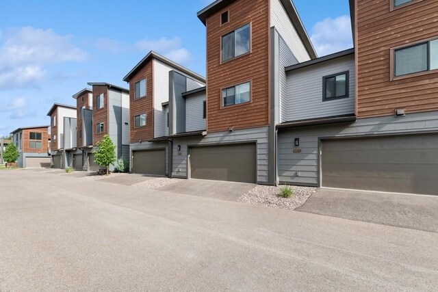 147 Hawthorne Ct Unit B, Whitefish, MT 59937 - exterior space with a garage, a residential view, and driveway
