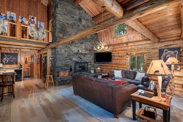1835 Emmons Canyon Rd, Kila, MT 59920 - living area featuring log walls, high vaulted ceiling, hardwood / wood-style floors, wood ceiling with exposed beams, and wine cooler