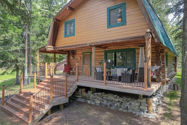 1835 Emmons Canyon Rd, Kila, MT 59920 - view of front of house with log siding, a wooden deck, stairs, and metal roof