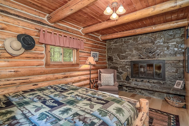 1835 Emmons Canyon Rd, Kila, MT 59920 - bedroom featuring wooden ceiling with exposed beams, rustic walls, hardwood / wood-style floors, and a stone fireplace