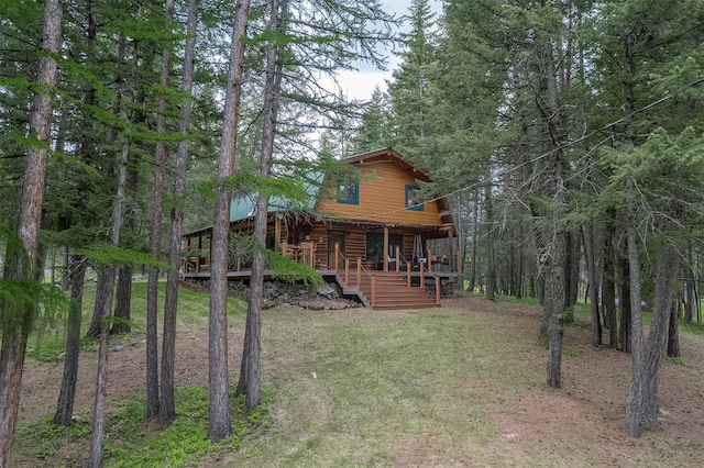 1835 Emmons Canyon Rd, Kila, MT 59920 - back of property featuring a porch, a lawn, and a view of trees