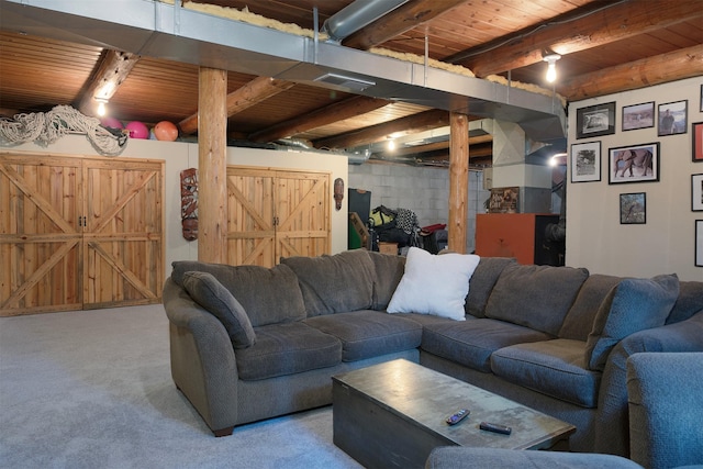 1835 Emmons Canyon Rd, Kila, MT 59920 - living room with wood ceiling with exposed beams, carpet, and concrete block wall