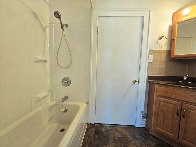 515 7th St N, Great Falls, MT 59401 - bathroom featuring vanity, shower / tub combination, tile walls, and stone finish flooring
