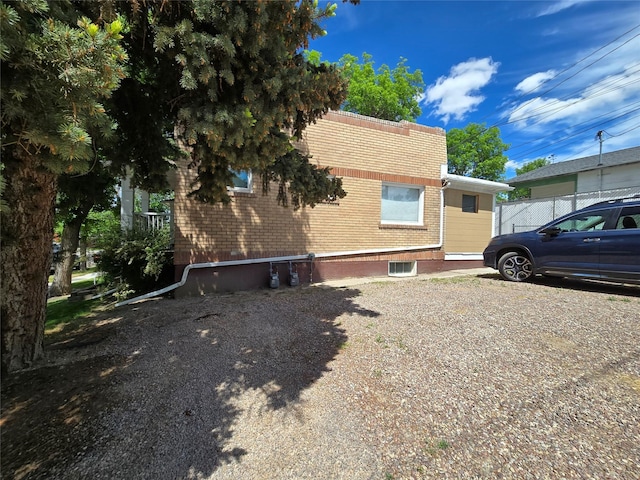515 7th St N, Great Falls, MT 59401 - view of home's exterior with brick siding and central AC unit