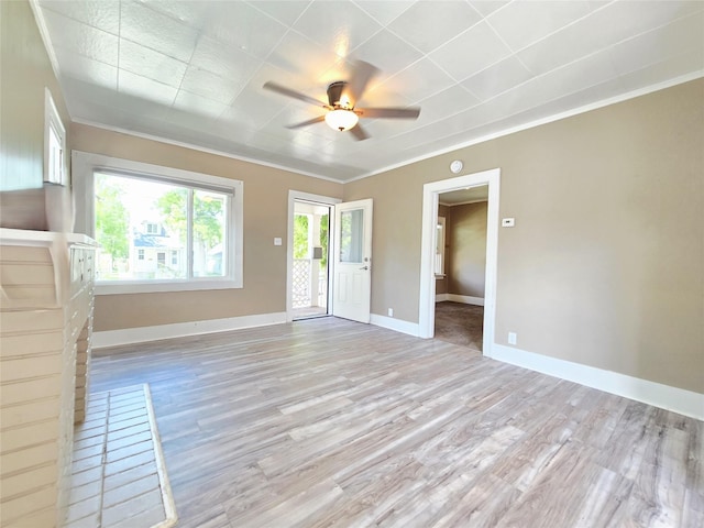 515 7th St N, Great Falls, MT 59401 - unfurnished living room with light wood-style floors, a ceiling fan, ornamental molding, and baseboards