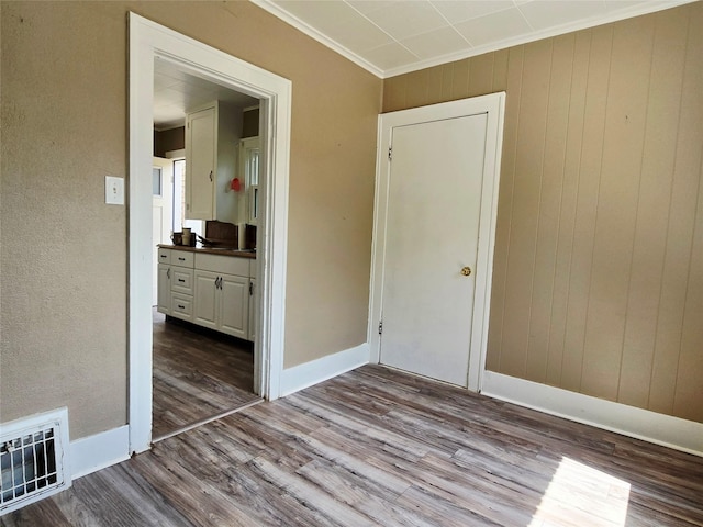 515 7th St N, Great Falls, MT 59401 - unfurnished room featuring dark wood-style floors, ornamental molding, baseboards, and wood walls