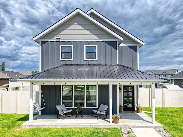 845 Mountain Vista Way, Kalispell, MT 59901 - back of house with board and batten siding, a porch, metal roof, and a gate
