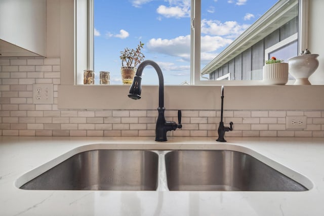 845 Mountain Vista Way, Kalispell, MT 59901 - kitchen view of a sink, backsplash, and light stone countertops