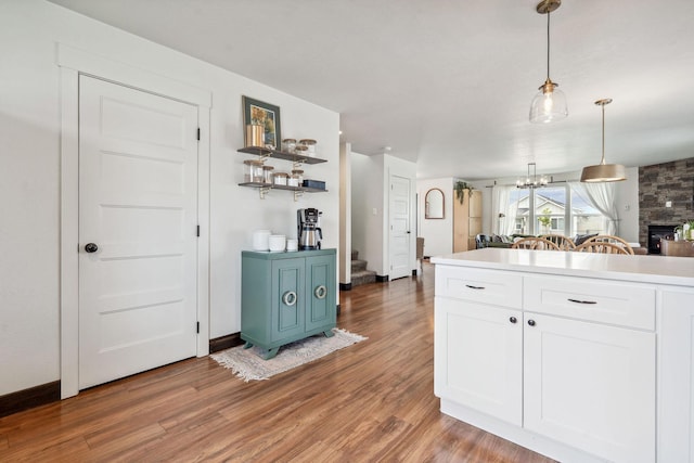845 Mountain Vista Way, Kalispell, MT 59901 - kitchen featuring white cabinetry, light wood-style floors, decorative light fixtures, open shelves, and light countertops