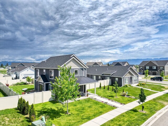 845 Mountain Vista Way, Kalispell, MT 59901 - view of front of property with a residential view, board and batten siding, roof with shingles, and a standing seam roof