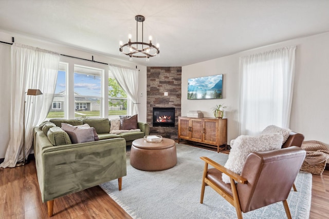 845 Mountain Vista Way, Kalispell, MT 59901 - living area featuring a chandelier, wood finished floors, and a tiled fireplace