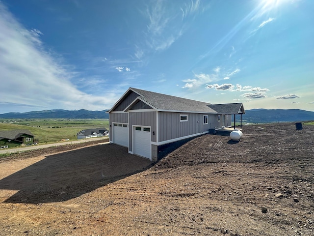 13463 Bunchgrass Ln, Missoula, MT 59808 - view of side of home featuring a mountain view and a garage