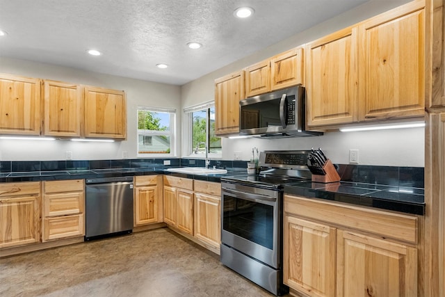 505 N 4th St, Hamilton, MT 59840 - kitchen featuring stainless steel appliances, light brown cabinets, a sink, recessed lighting, and a textured ceiling