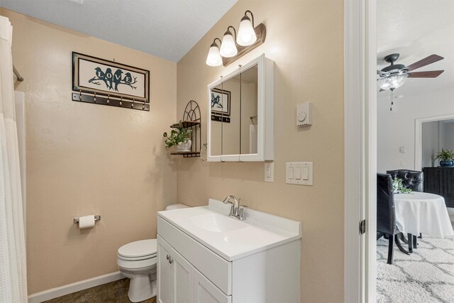 505 N 4th St, Hamilton, MT 59840 - full bathroom featuring toilet, vanity, a ceiling fan, and baseboards