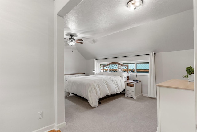 505 N 4th St, Hamilton, MT 59840 - bedroom featuring a textured ceiling, baseboards, vaulted ceiling, light carpet, and ceiling fan