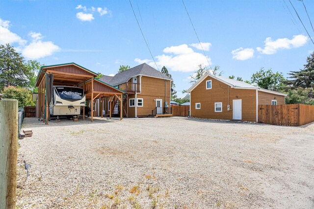 505 N 4th St, Hamilton, MT 59840 - back of property featuring gravel driveway, a carport, and stairway