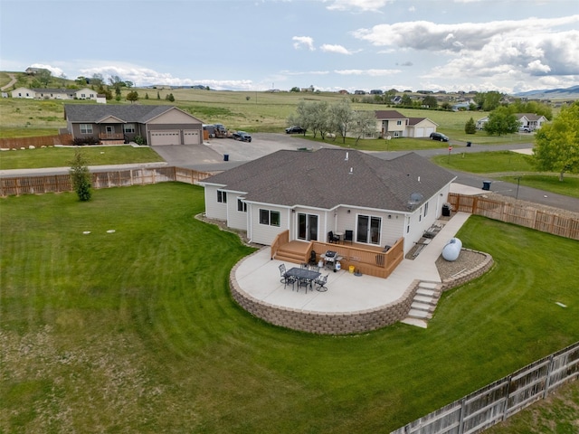 4288 Iverson Rd, Helena, MT 59602 - rear view of house featuring a garage, a patio, and a wooden deck