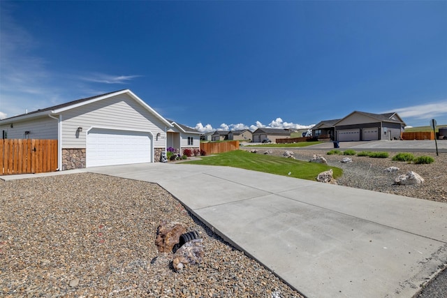 4288 Iverson Rd, Helena, MT 59602 - view of front of house with a garage, stone siding, driveway, and a residential view