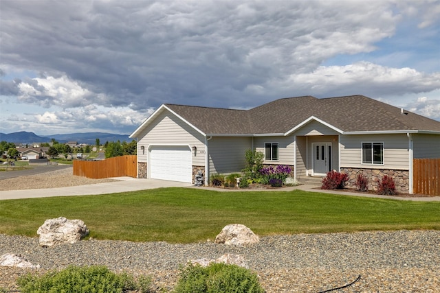 4288 Iverson Rd, Helena, MT 59602 - ranch-style house with stone siding, driveway, a shingled roof, an attached garage, and a mountain view
