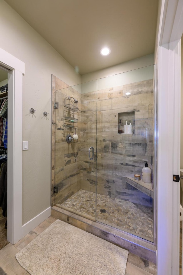 135 E Swift Creek Way, Kalispell, MT 59901 - bathroom featuring a shower stall, a walk in closet, recessed lighting, baseboards, and wood finished floors