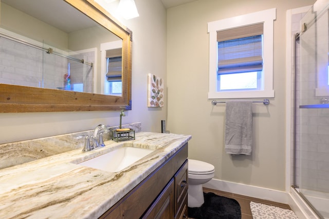 135 E Swift Creek Way, Kalispell, MT 59901 - bathroom with vanity, toilet, a shower stall, tile patterned floors, and baseboards