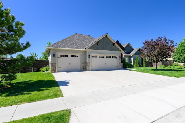 135 E Swift Creek Way, Kalispell, MT 59901 - craftsman inspired home with a garage, concrete driveway, and stone siding