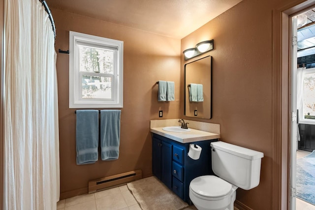 343 Deer Trl, Whitefish, MT 59937 - bathroom featuring a baseboard heating unit, vanity, toilet, tile patterned floors, and a textured wall