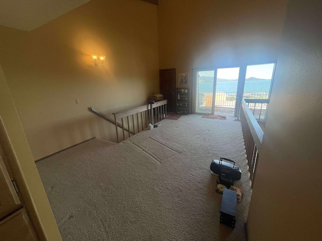 12 Country Club Dr Unit 16, Polson, MT 59860 - spare room featuring carpet flooring and high vaulted ceiling