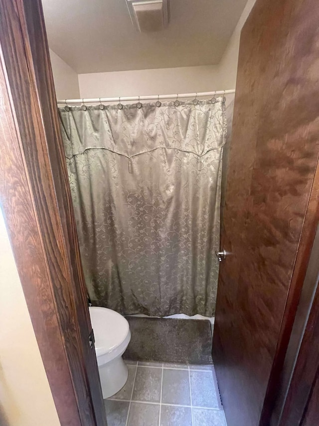12 Country Club Dr Unit 16, Polson, MT 59860 - bathroom featuring tile patterned flooring, toilet, and a shower with curtain