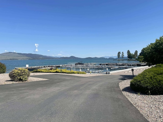12 Country Club Dr Unit 16, Polson, MT 59860 - view of asphalt road featuring a water and mountain view