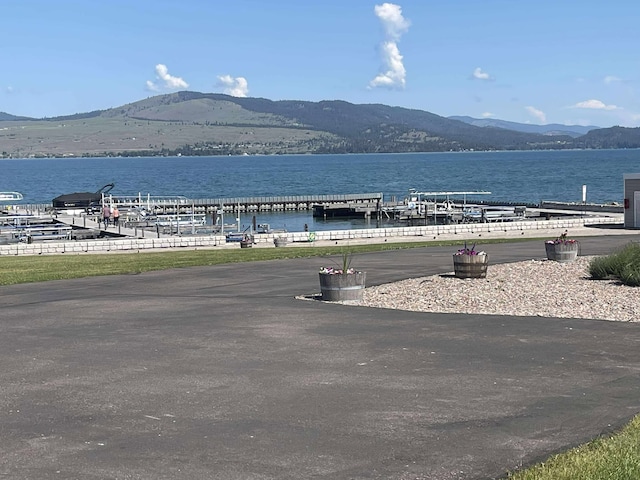 12 Country Club Dr Unit 16, Polson, MT 59860 - water view featuring a mountain backdrop and a boat dock
