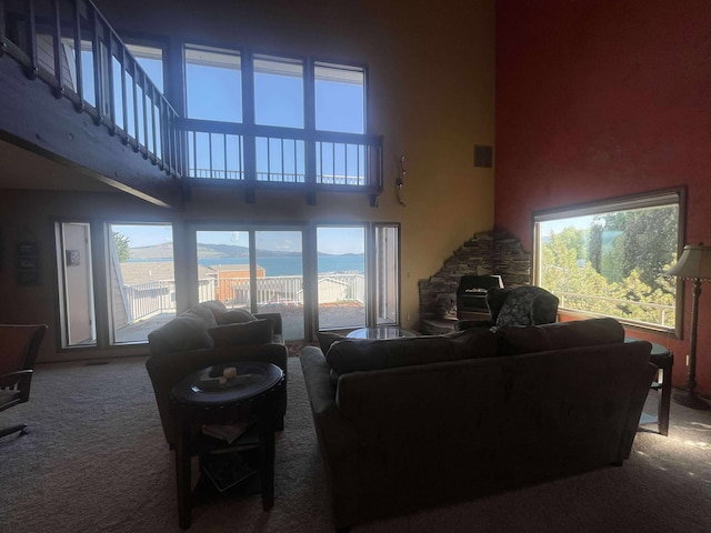 12 Country Club Dr Unit 16, Polson, MT 59860 - carpeted living room featuring a high ceiling, healthy amount of natural light, and a water view