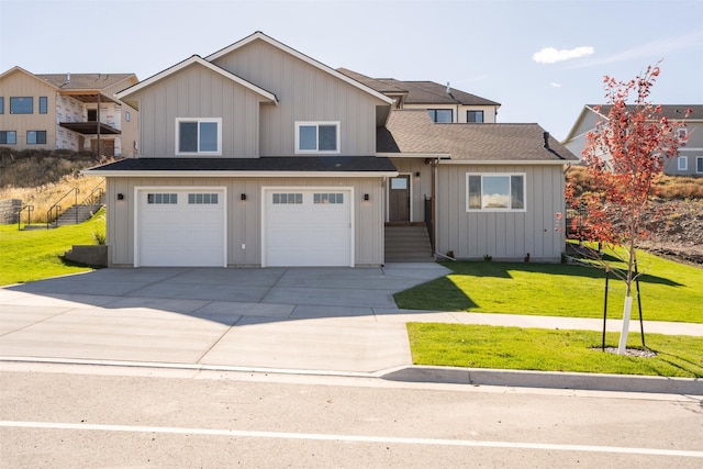 4337 Christian Dr, Missoula, MT 59803 - view of front of home with driveway, an attached garage, a front yard, roof with shingles, and board and batten siding