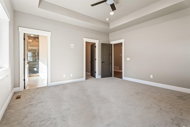 4337 Christian Dr, Missoula, MT 59803 - unfurnished bedroom featuring light carpet, a walk in closet, baseboards, a raised ceiling, and recessed lighting