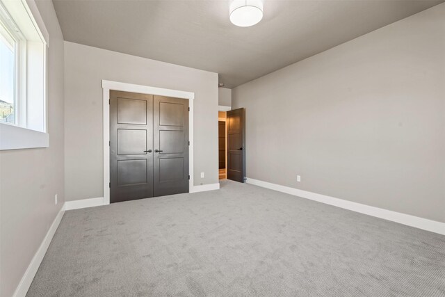 4337 Christian Dr, Missoula, MT 59803 - unfurnished bedroom featuring baseboards, carpet floors, and a closet
